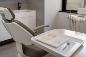 Ceramic crown samples and a shade guide in a modern dental treatment room